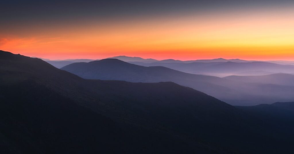 Silhouette of mountains against a sunrise, representing a new beginning