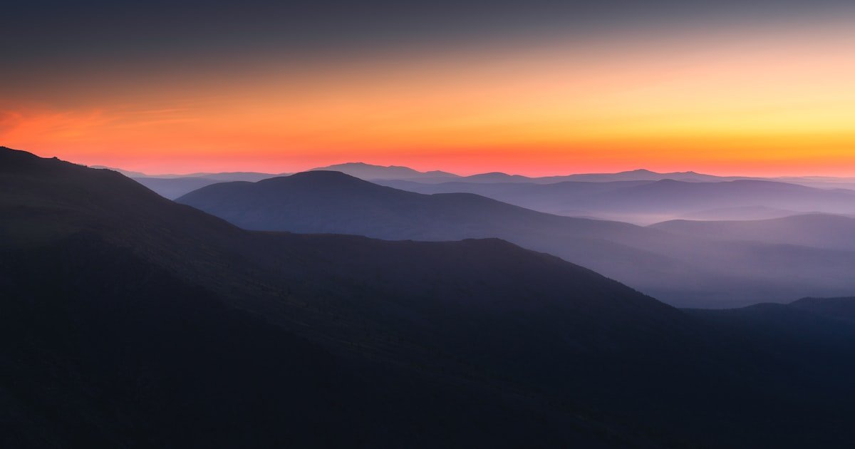 Silhouette of mountains against a sunrise, representing a new beginning