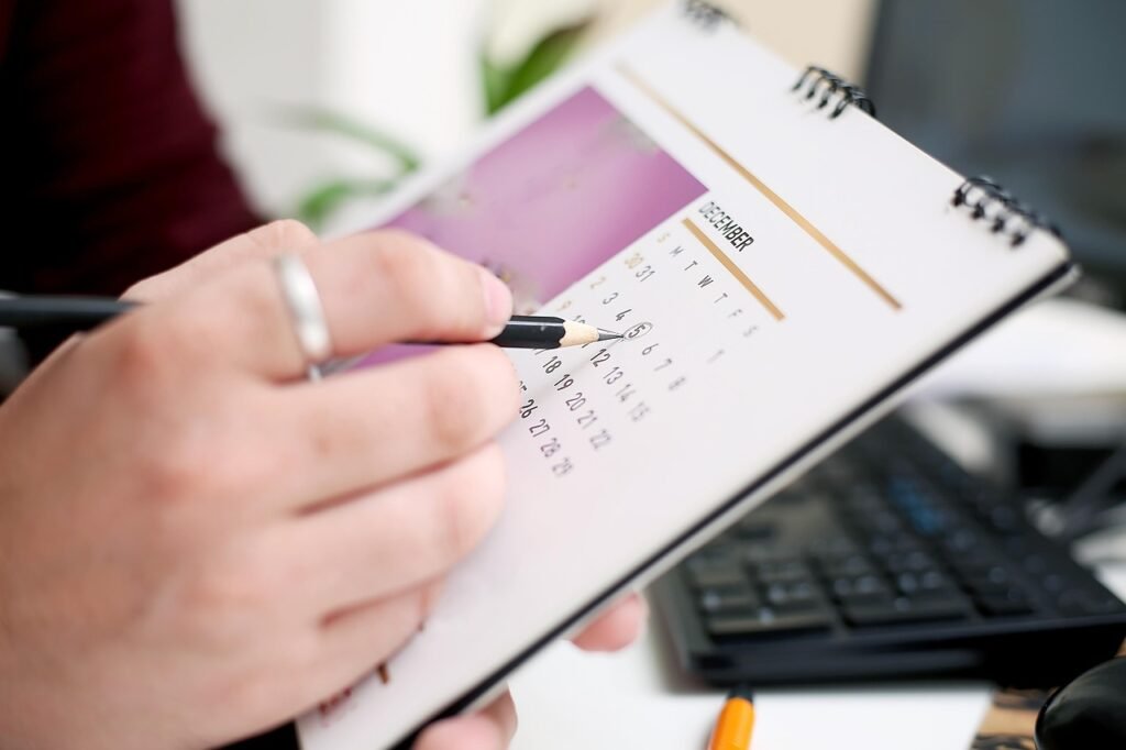 A calendar and planner laid out on a desk, marking the start of a new month.