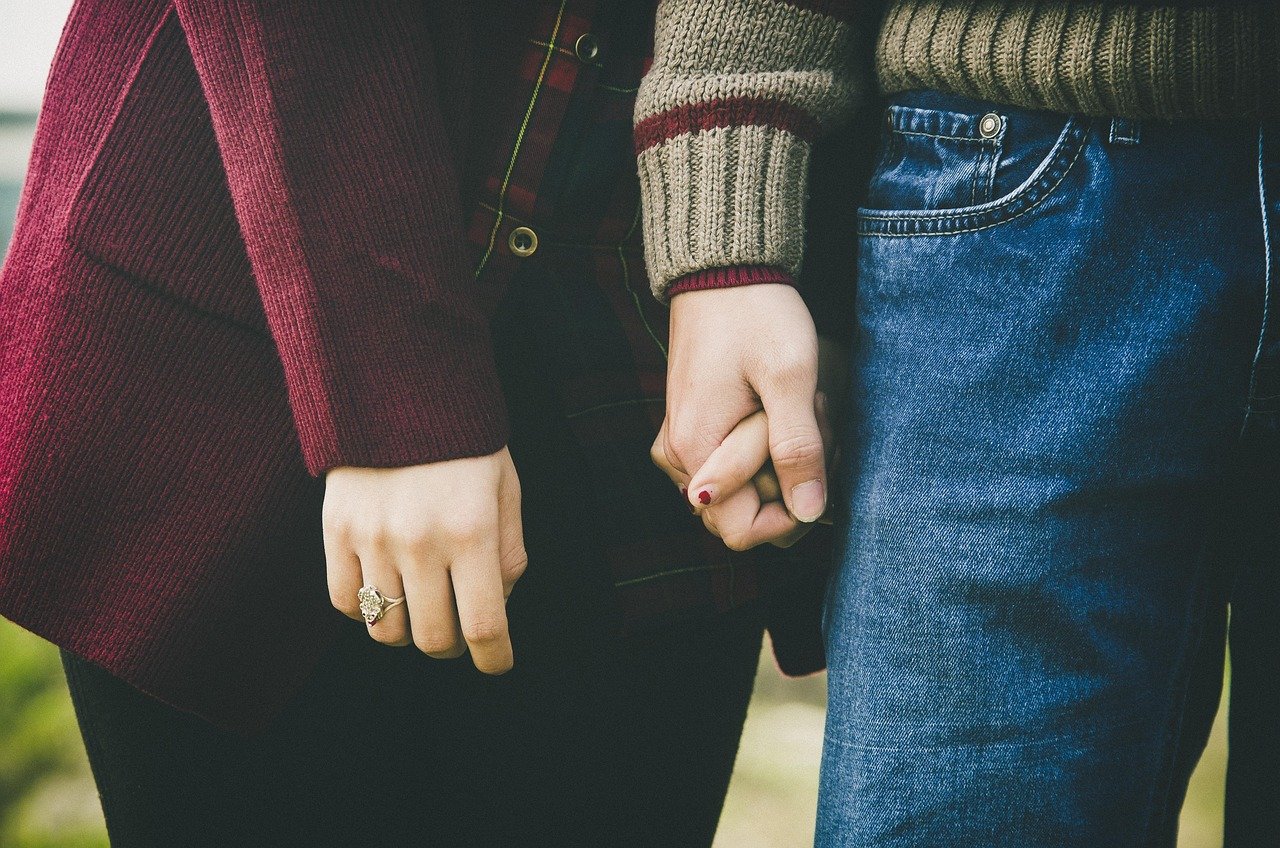 Couple holding hands, a sign of trust and connection in a healthy relationship